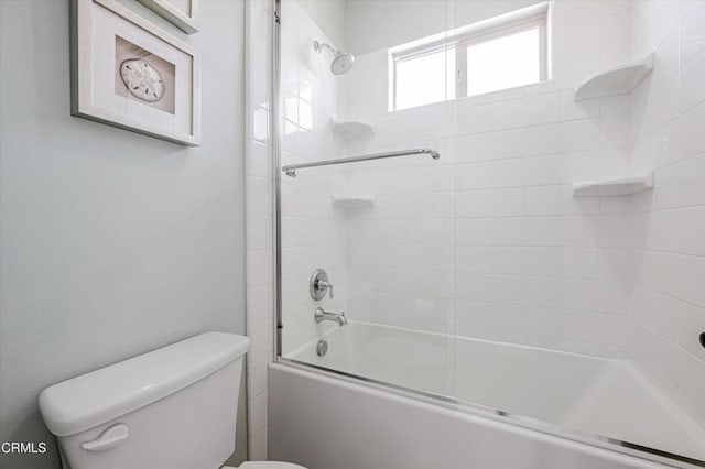 full bathroom with toilet and bath / shower combo with glass door