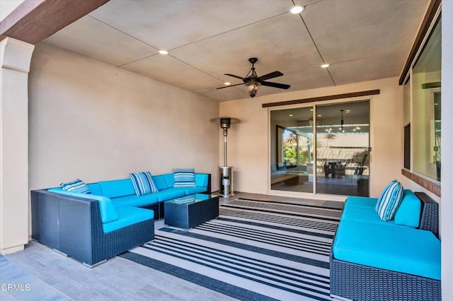 view of patio with an outdoor living space and a ceiling fan