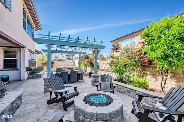view of patio featuring an outdoor fire pit, a fenced backyard, a pergola, and outdoor dining area
