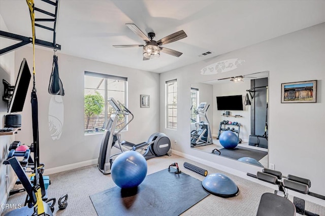 workout room with carpet floors, baseboards, a ceiling fan, and visible vents