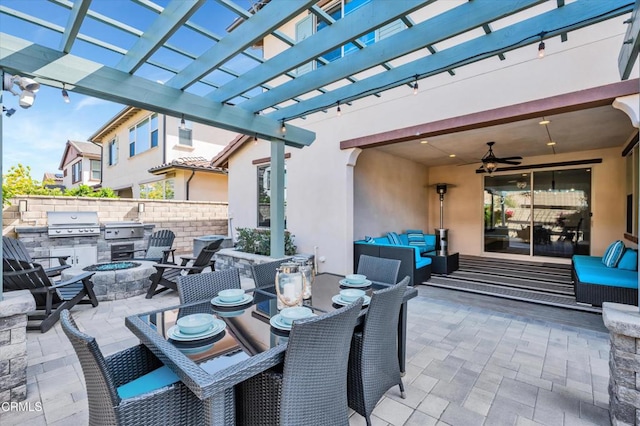 view of patio / terrace with exterior kitchen, a pergola, a grill, an outdoor living space with a fire pit, and fence