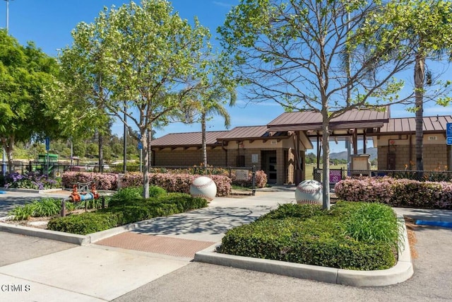 view of home's community featuring fence