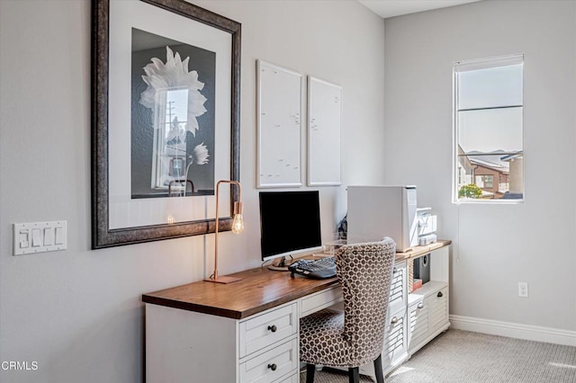 home office with light colored carpet and baseboards
