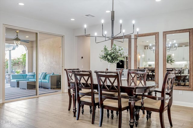 dining space featuring baseboards, recessed lighting, light wood-style flooring, visible vents, and ceiling fan with notable chandelier