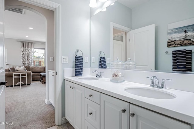 bathroom with a sink, visible vents, and double vanity