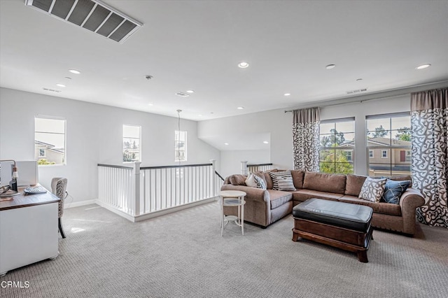 carpeted living area with recessed lighting and visible vents