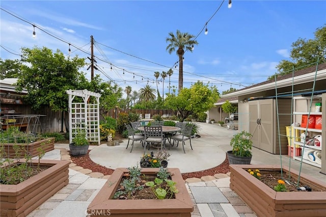 5303 Avondale Way, Riverside, CA 92506 - view of patio with a fenced backyard, a vegetable garden, and outdoor dining space