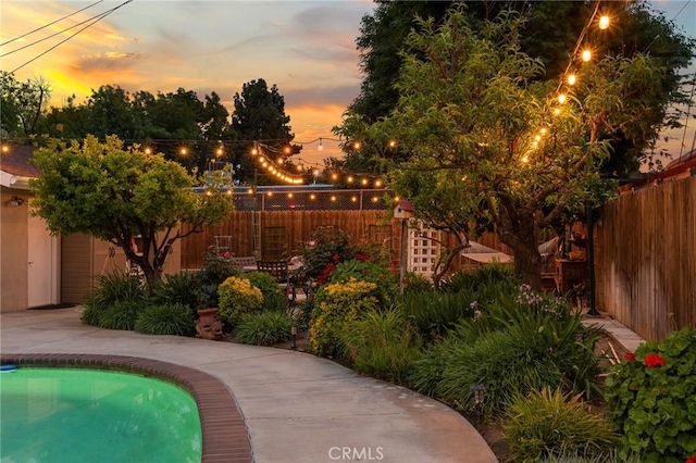 5303 Avondale Way, Riverside, CA 92506 - pool at dusk featuring fence
