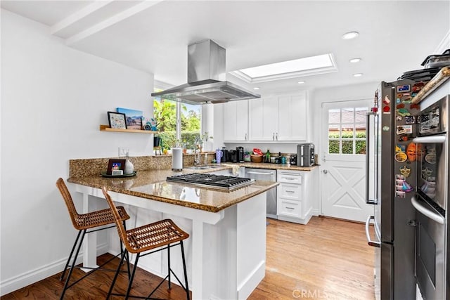 2818 Francis Ln, Costa Mesa, CA 92626 - kitchen with a peninsula, white cabinets, island exhaust hood, stone counters, and stainless steel appliances