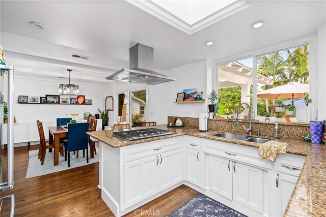 2818 Francis Ln, Costa Mesa, CA 92626 - kitchen featuring visible vents, a peninsula, island exhaust hood, a sink, and stainless steel gas stovetop
