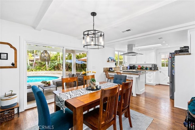 2818 Francis Ln, Costa Mesa, CA 92626 - dining room featuring beamed ceiling, a chandelier, visible vents, and light wood-type flooring