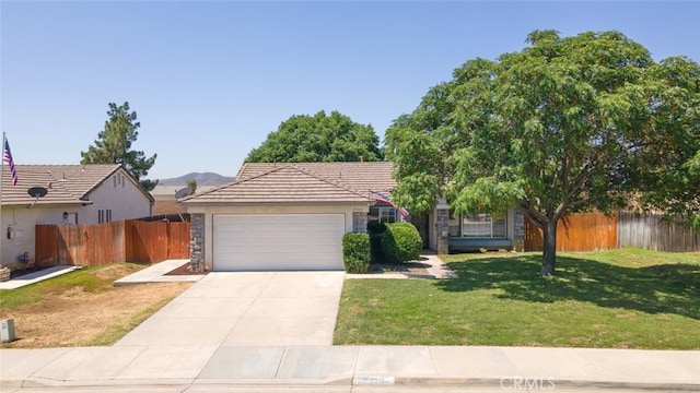 29129 Crestline Dr, Menifee, CA 92584 - view of front of house with concrete driveway, a garage, stone siding, and a tiled roof