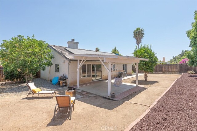 29129 Crestline Dr, Menifee, CA 92584 - back of property featuring a patio area, a fenced backyard, stucco siding, and a chimney