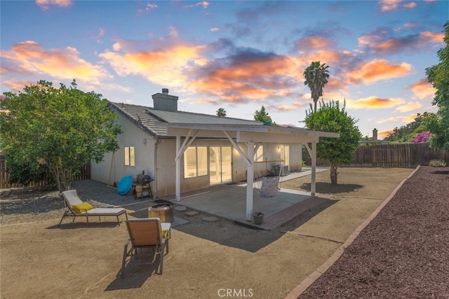 29129 Crestline Dr, Menifee, CA 92584 - rear view of property featuring a patio area, a chimney, a fenced backyard, stucco siding, and a tiled roof