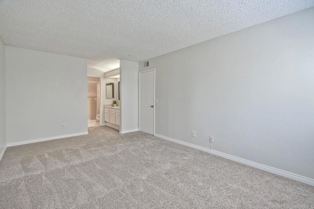 321 N Melrose Dr Unit A, Vista, CA 92083 - spare room with visible vents, baseboards, light carpet, and a textured ceiling
