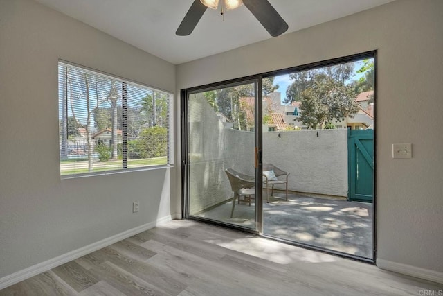 321 N Melrose Dr Unit A, Vista, CA 92083 - doorway to outside with light wood-style floors, ceiling fan, and baseboards
