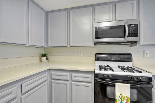 321 N Melrose Dr Unit A, Vista, CA 92083 - kitchen with stainless steel microwave, gas range, and light countertops