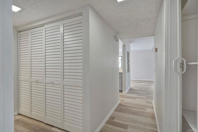 321 N Melrose Dr Unit A, Vista, CA 92083 - hallway featuring light wood-style flooring, a textured ceiling, and baseboards