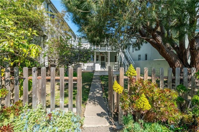 exterior space with a fenced front yard and stairs