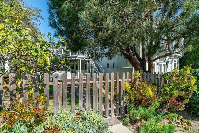 exterior space featuring stairway and a fenced front yard