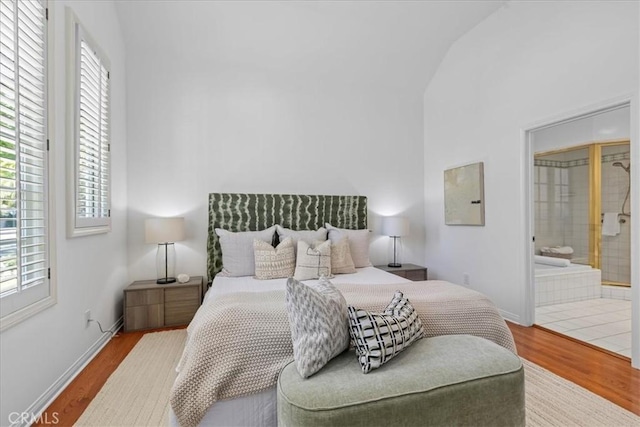 2824 Westwood Blvd, Los Angeles, CA 90064 - bedroom featuring baseboards, connected bathroom, wood finished floors, and lofted ceiling
