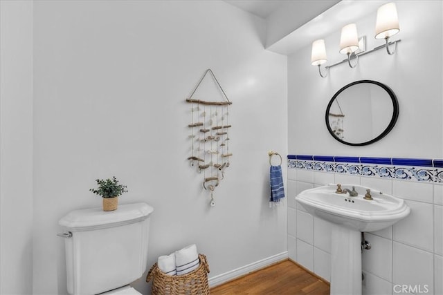 2824 Westwood Blvd, Los Angeles, CA 90064 - half bathroom with tile walls, toilet, and wood finished floors