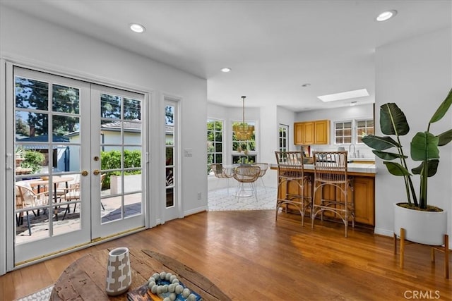 2824 Westwood Blvd, Los Angeles, CA 90064 - doorway to outside featuring a skylight, recessed lighting, light wood-type flooring, and a wealth of natural light