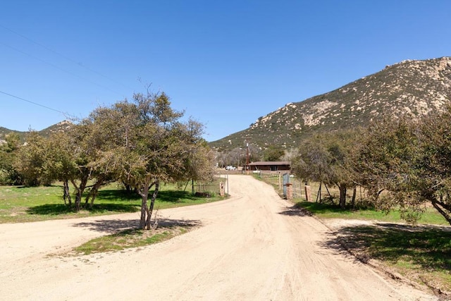 2483 Buckman Springs Rd, Campo, CA 91906 - view of street with a rural view, a gated entry, a mountain view, and dirt driveway