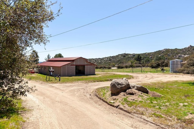 2483 Buckman Springs Rd, Campo, CA 91906 - view of road with a rural view, dirt driveway, a mountain view, and a pole building