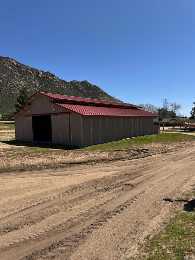 2483 Buckman Springs Rd, Campo, CA 91906 - view of side of home featuring an outdoor structure, a mountain view, and an outbuilding