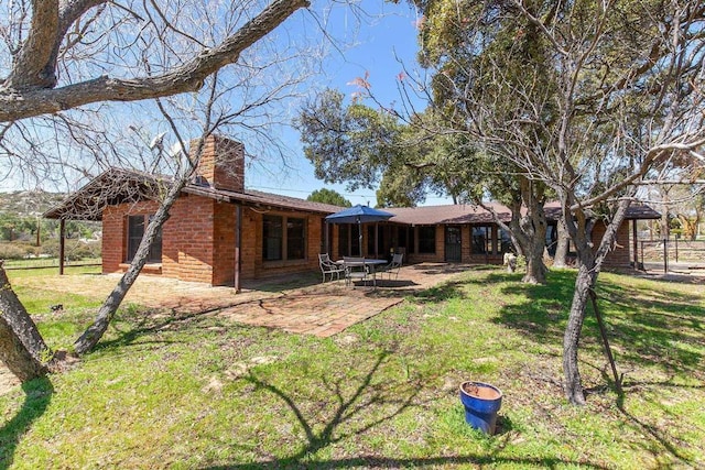 2483 Buckman Springs Rd, Campo, CA 91906 - back of property with brick siding, a yard, a patio, and a chimney