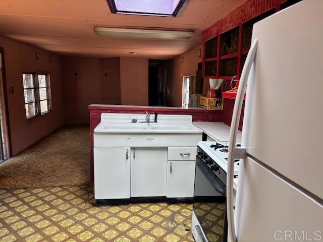 2483 Buckman Springs Rd, Campo, CA 91906 - kitchen with white appliances, white cabinetry, a peninsula, light countertops, and light floors
