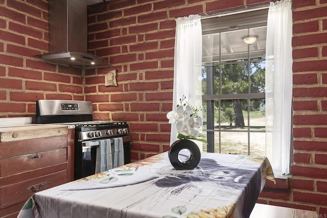 2483 Buckman Springs Rd, Campo, CA 91906 - kitchen with stainless steel gas stove, island exhaust hood, tile countertops, and brick wall