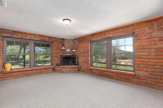 2483 Buckman Springs Rd, Campo, CA 91906 - unfurnished living room with healthy amount of natural light, carpet, a brick fireplace, a textured ceiling, and brick wall