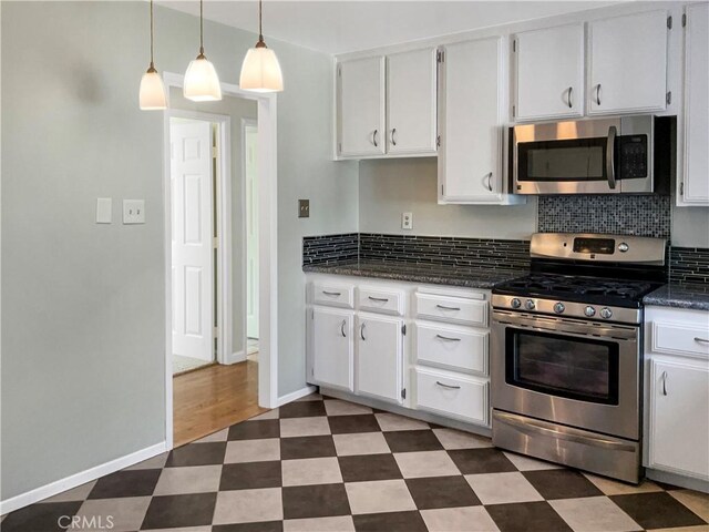 529 Esther Way, Redlands, CA 92373 - kitchen with white cabinetry, baseboards, appliances with stainless steel finishes, and dark floors