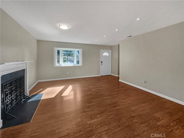 529 Esther Way, Redlands, CA 92373 - unfurnished living room featuring baseboards, wood finished floors, and a fireplace with raised hearth