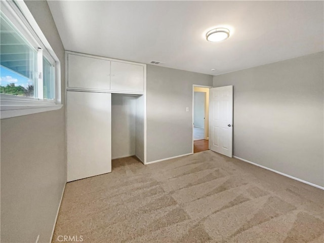 529 Esther Way, Redlands, CA 92373 - unfurnished bedroom featuring light colored carpet, visible vents, a closet, and baseboards