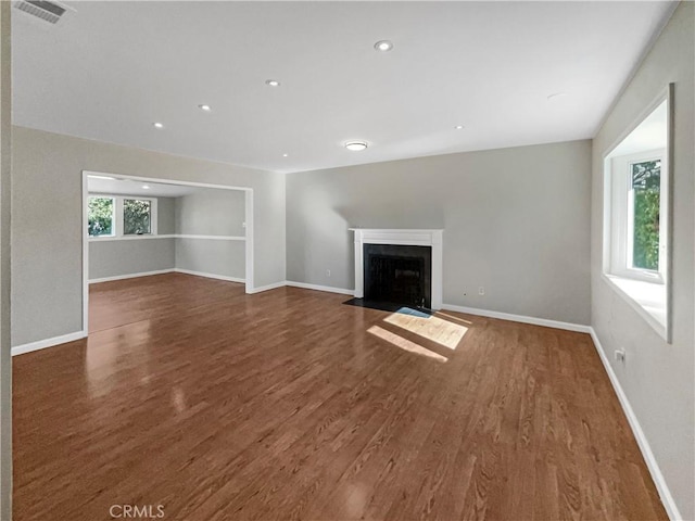 529 Esther Way, Redlands, CA 92373 - unfurnished living room featuring a fireplace with flush hearth, visible vents, baseboards, recessed lighting, and wood finished floors