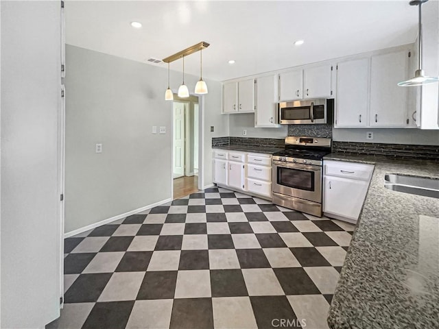 529 Esther Way, Redlands, CA 92373 - kitchen with dark stone counters, a sink, stainless steel appliances, decorative light fixtures, and white cabinets