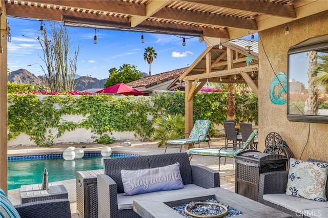 43590 Warner Trl, Palm Desert, CA 92211 - view of patio featuring a pergola, an outdoor pool, a mountain view, and an outdoor living space with a fire pit