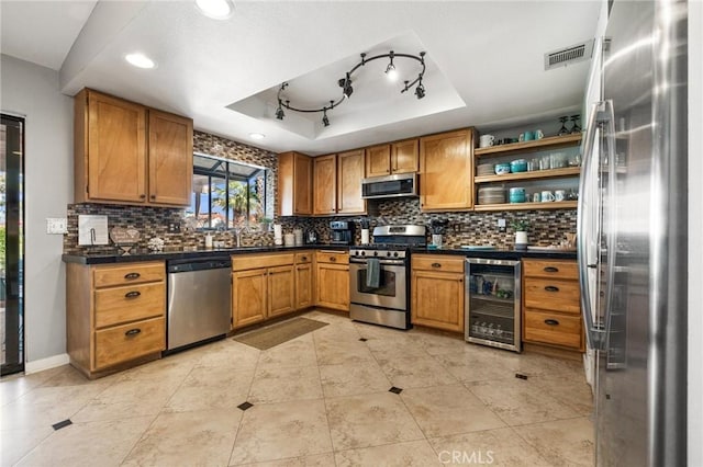 43590 Warner Trl, Palm Desert, CA 92211 - kitchen with beverage cooler, open shelves, brown cabinets, and stainless steel appliances
