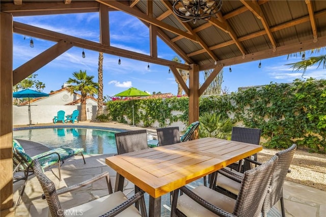 43590 Warner Trl, Palm Desert, CA 92211 - view of patio featuring a fenced backyard, a storage unit, a fenced in pool, an outbuilding, and outdoor dining space