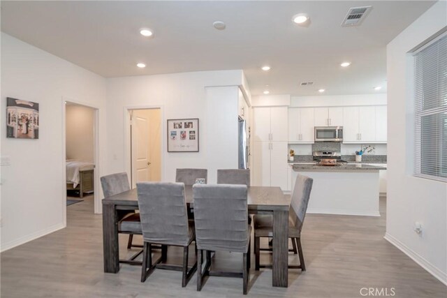 15188 Horizon St Unit 8, Fontana, CA 92336 - dining area featuring wood finished floors, baseboards, and visible vents