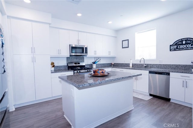 15188 Horizon St Unit 8, Fontana, CA 92336 - kitchen with wood finished floors, a sink, white cabinetry, and stainless steel appliances