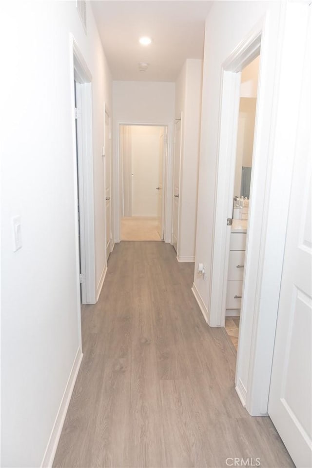 15188 Horizon St Unit 8, Fontana, CA 92336 - hall featuring light wood-type flooring, baseboards, and visible vents