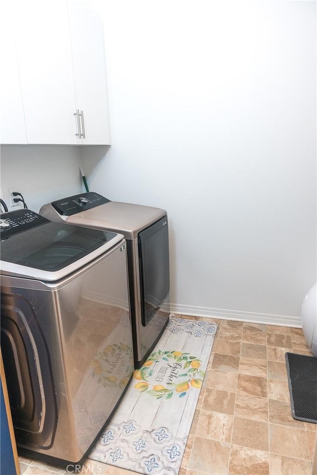 15188 Horizon St Unit 8, Fontana, CA 92336 - clothes washing area featuring washer and dryer, stone finish floor, baseboards, and cabinet space