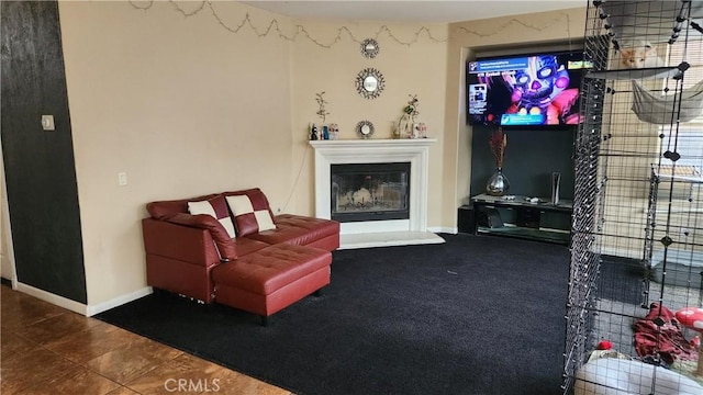 12613 Torrey Pine Rd, Moreno Valley, CA 92555 - living area featuring a glass covered fireplace, baseboards, and tile patterned flooring