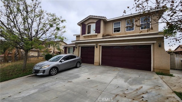 12613 Torrey Pine Rd, Moreno Valley, CA 92555 - view of front of property with stucco siding, an attached garage, and concrete driveway