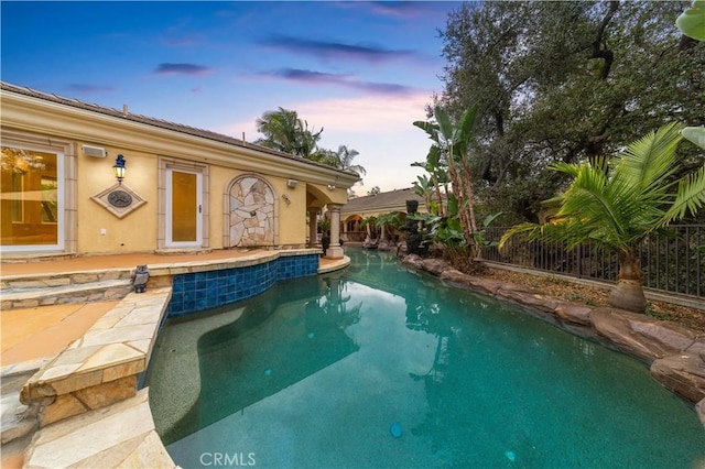 1199 Village Dr, Chino Hills, CA 91709 - pool at dusk featuring an outdoor pool, fence, and a patio area