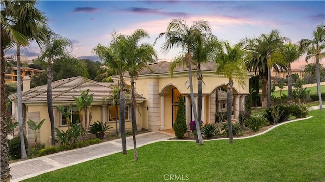 1199 Village Dr, Chino Hills, CA 91709 - view of front of house with stucco siding, a front yard, and a tile roof